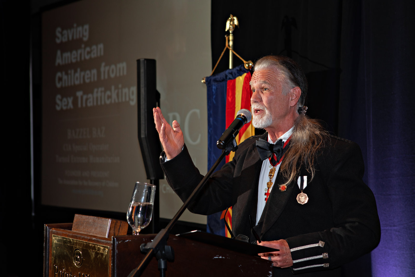 A speaker addressing guests about protecting American children from sex trafficking